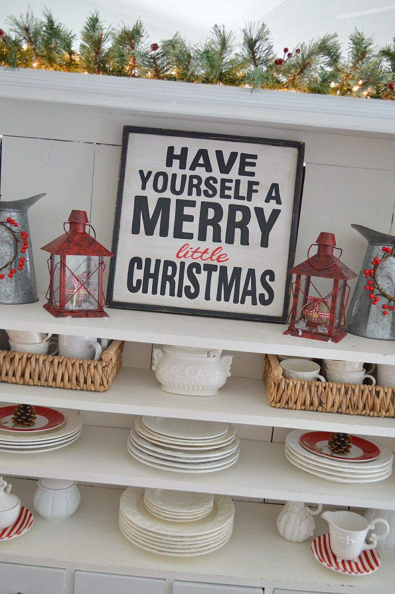 Apothecary Cabinet Open Cabinet Shelves with our Have Yourself A Merry Little Christmas wood sign. Red Lanterns filled with Plaid and Gingham Check ornaments. It's a Cottage Christmas Home Tour at foxhollowcottage.com