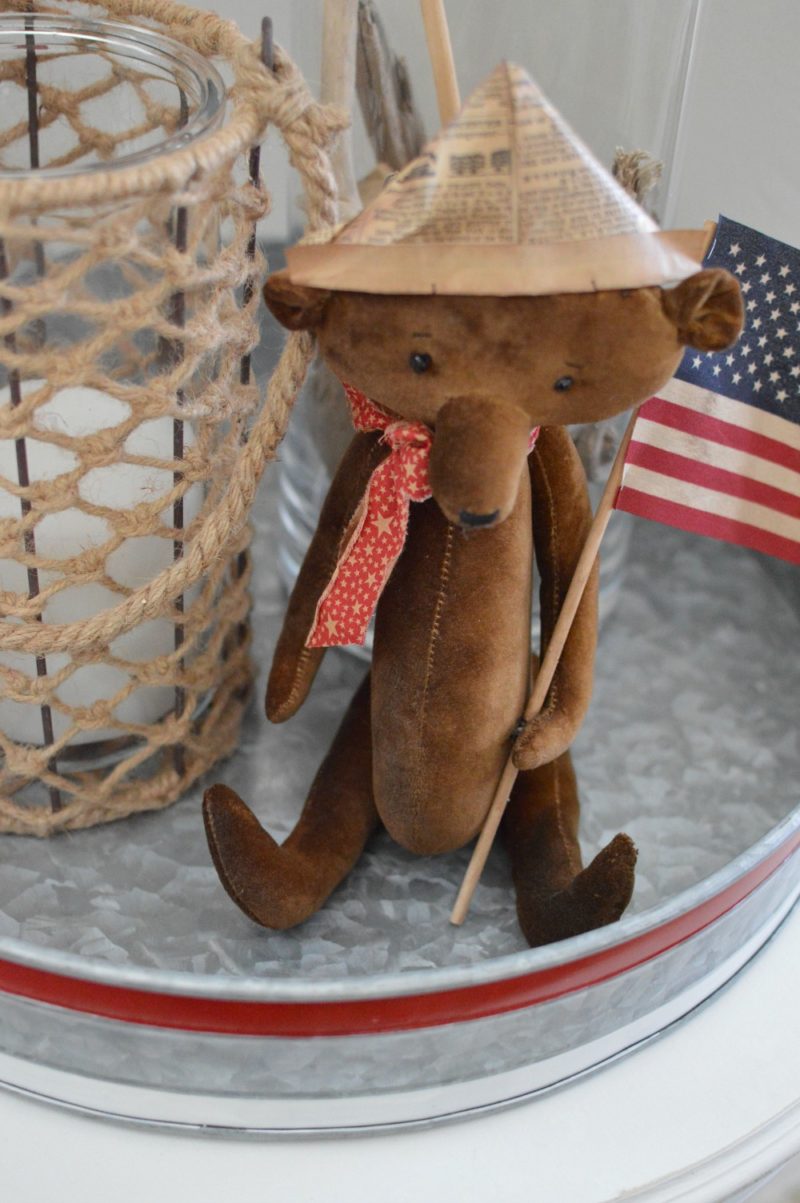 Vintage teddy bear with newspaper hat