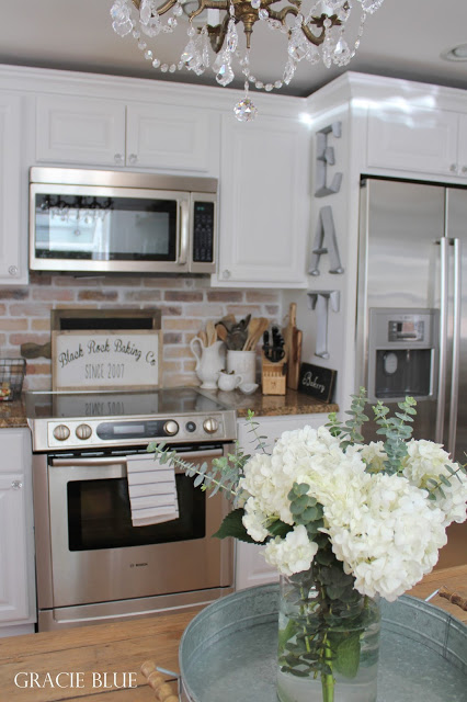 White Kitchen Makeover with Stainless Steel Appliances, adding farmhouse charm by Gracie Blue