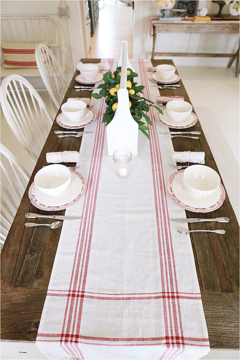 Life On The Shady Grove White Farmhouse Home Tour at Fox Hollow Cottage. Wood farmhouse table with grain-sack runner and Lemon enterpiece