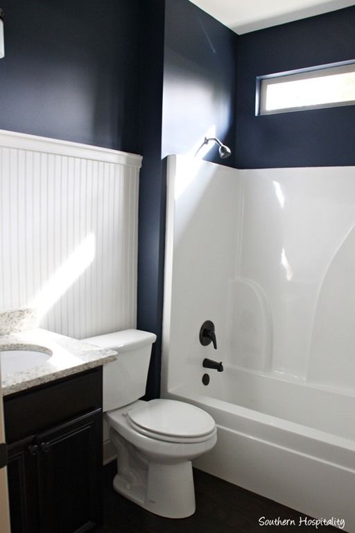Navy Bathroom Decorating Ideas - Dark walls and white beadboard accent feature wall. Southern Hospitality blog