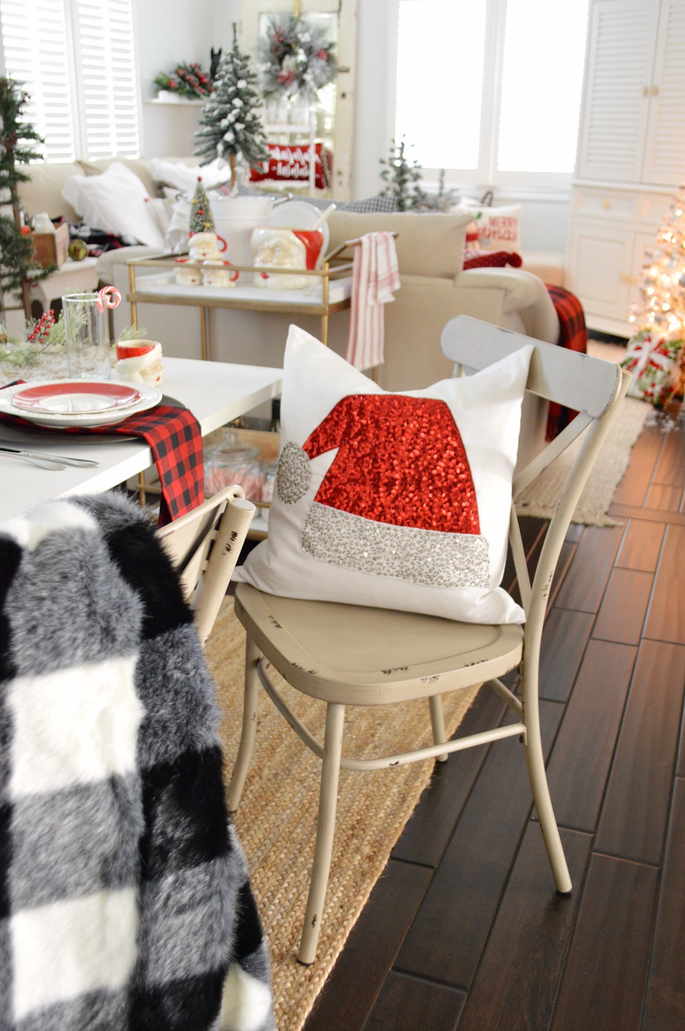Cottage Farmhouse Christmas Dining Room, red black, white buffalo check rustic traditional farm table with cranberry floating candle centerpiece.